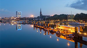 Image of reflection of Bremen skyline in the calm waters of river Weser, In Bremen, Germany