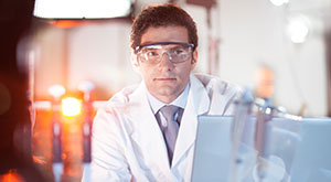 The PhD Application Process in Germany - Image of male scientist wearing protective eyewear in a lab