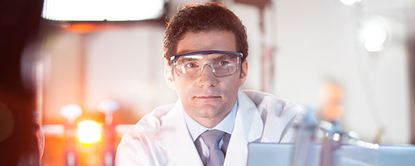 The PhD Application Process in Germany - Image of male scientist wearing protective eyewear in a lab