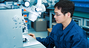 Alternative Research Career Options in Germany - Image of a male in blue overalls inspects work